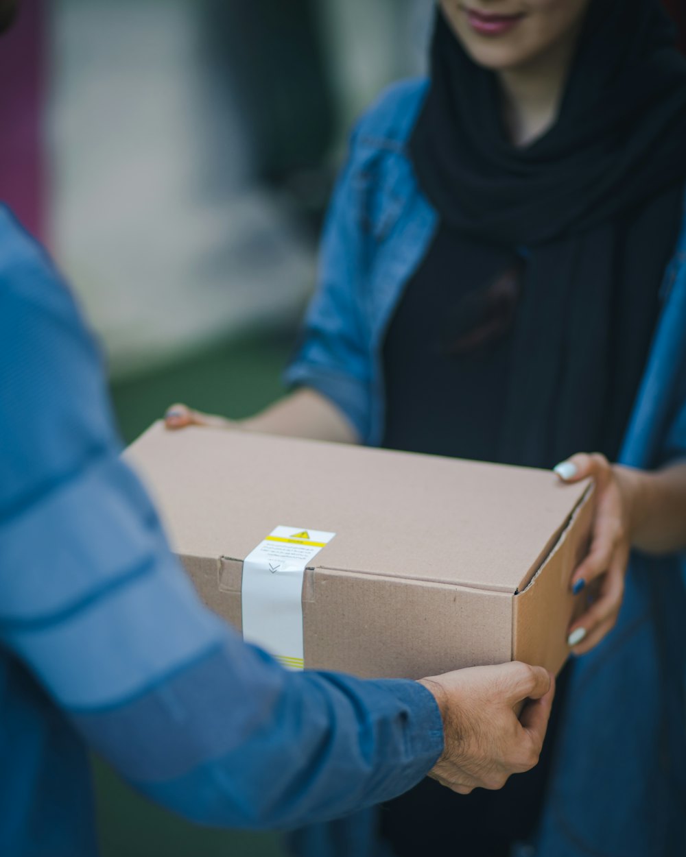 Door-to-door last-mile delivery &mdash; a packed carton handed over at the point of delivery